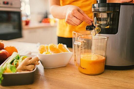 Uma variedade colorida de frutas e vegetais frescos, incluindo cenouras, espinafre, maçãs e beterrabas, prontos para serem transformados em sucos nutritivos.